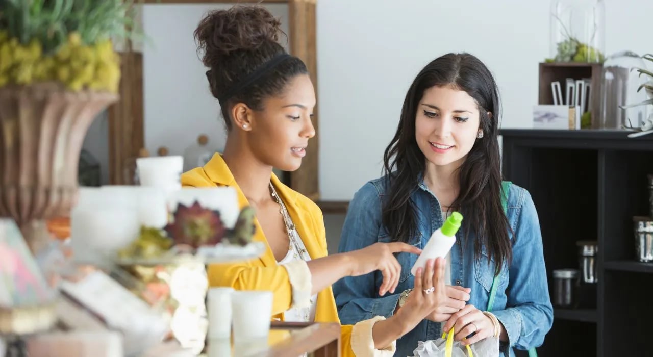 A retail salesperson showing a product to a customer