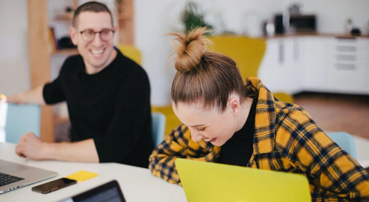 Two colleagues working together at their desk